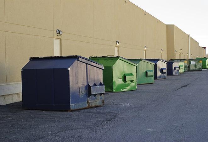 a collection of bright and vibrant dumpsters in a construction zone in Bloomfield